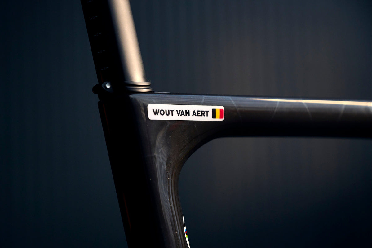 Wout van Aert’s name sticker with the Belgian flag on the black carbon frame of his road bike