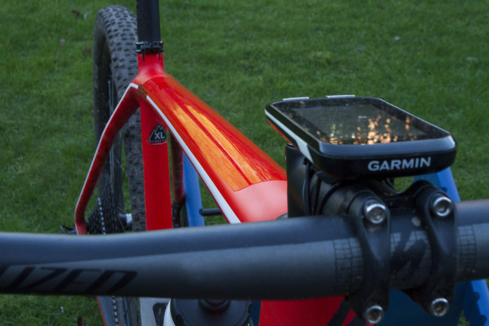 Transparent PPF protection film on the top tube of a mountain bike, by the handlebars and bike computer