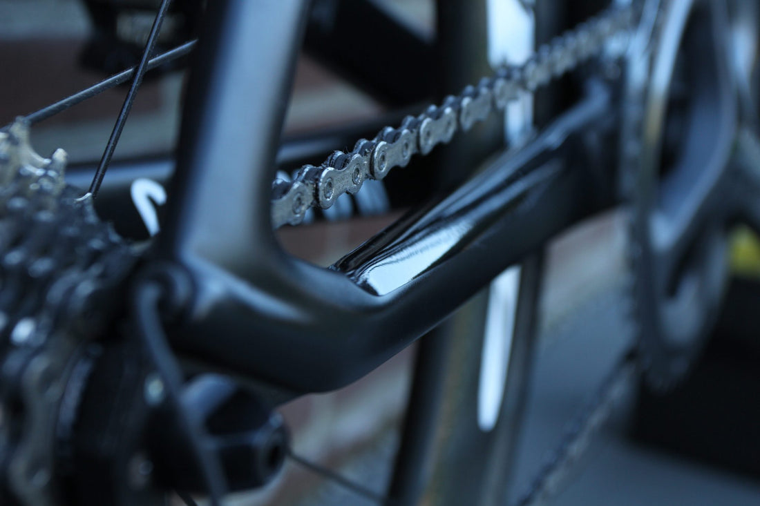 Transparent PPF protection film on the chainstay of a black bike, against chain slap
